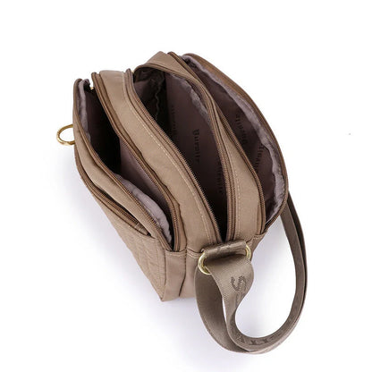 Compact nylon messenger bag for women in various colours with adjustable strap