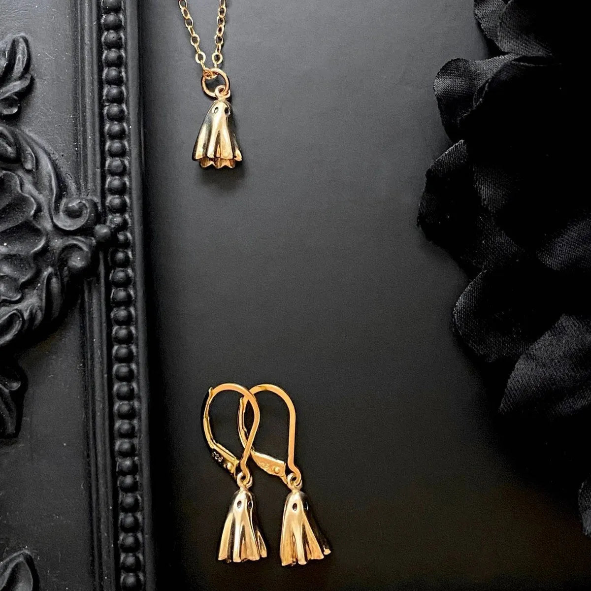 Ghost pendant necklace with titanium steel construction and electroplated finish on twisted chain