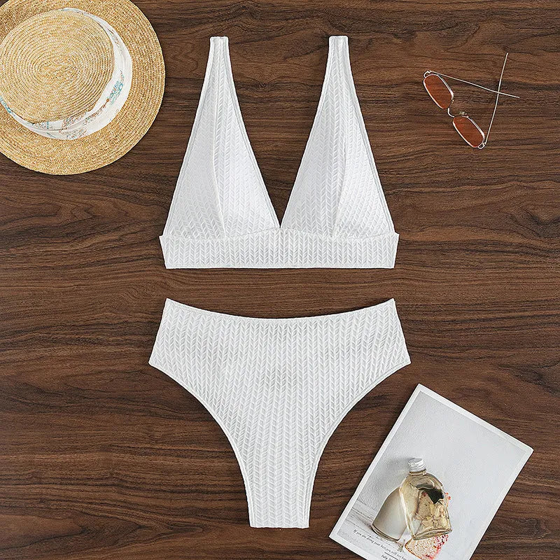 White women's backless bikini swimsuit with brief cut, laid flat showing bra and panties.