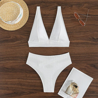 White women's backless bikini swimsuit with brief cut, laid flat showing bra and panties.