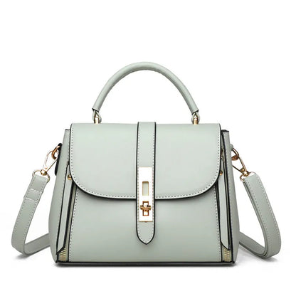 Women's soft black PU leather square messenger bag with a single shoulder strap on a table.