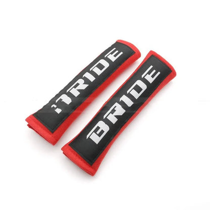 Car seat belt shoulder pad protectors in black, blue, and red colours with embroidered woven detailing