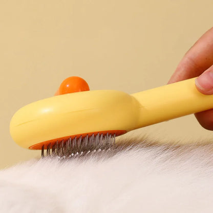 Small yellow duck-shaped plastic comb for grooming cats and dogs, with open needle teeth.
