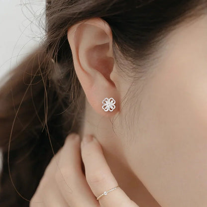 Elegant sterling silver stud earrings with delicate floral accents, suitable for both men and women