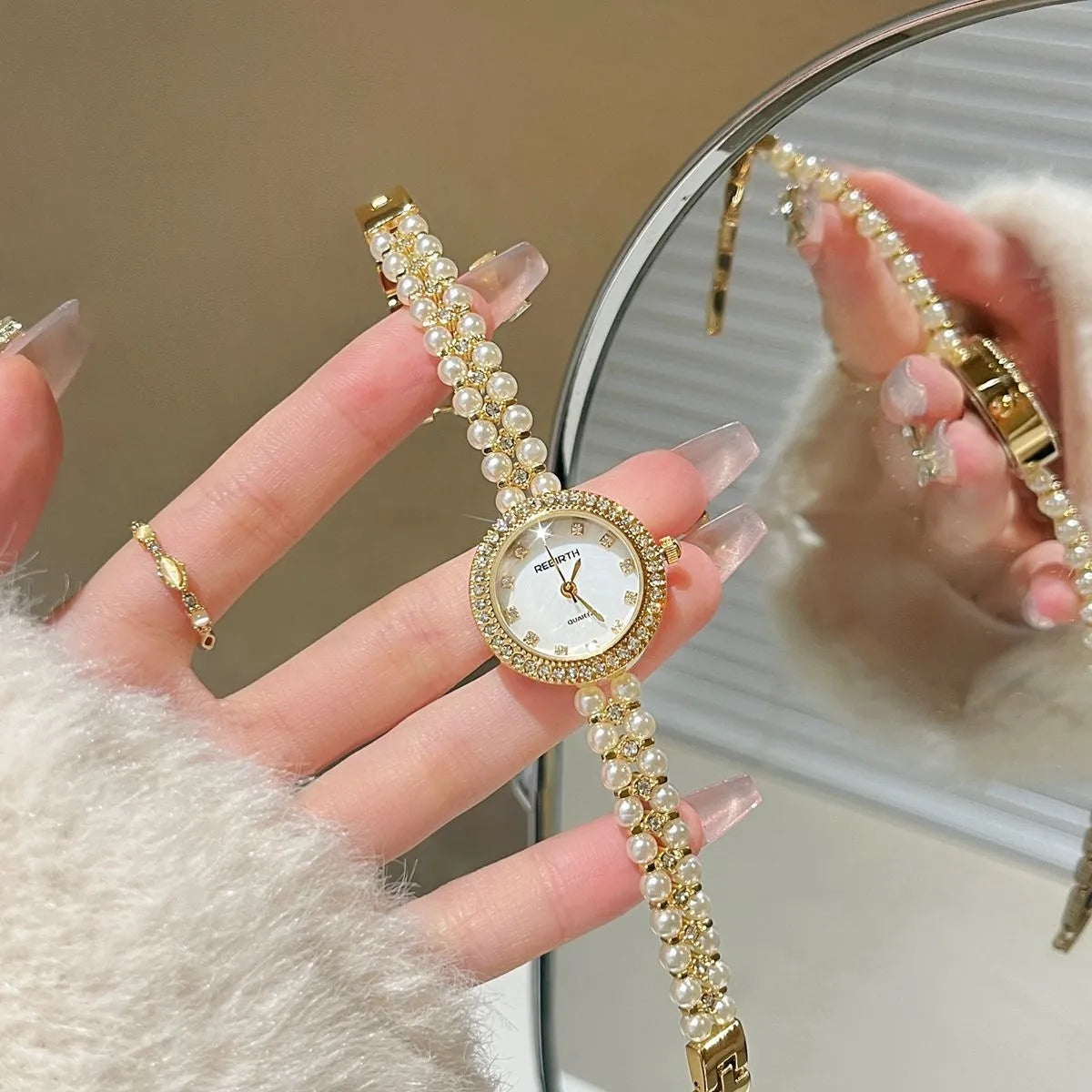 Women's vintage freshwater pearl bracelet watch with 25mm dial, steel strap, and double row pearl design in silver
