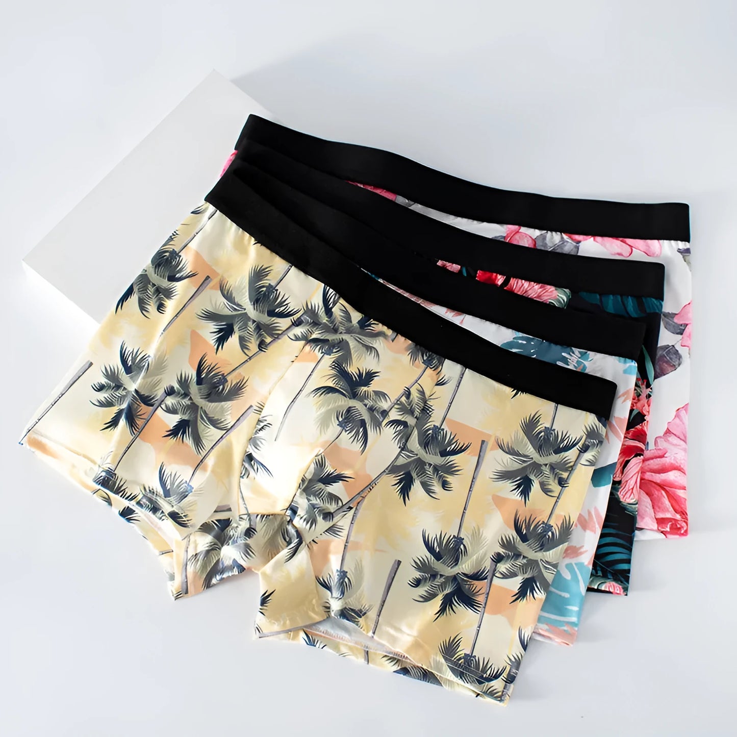 Men's printed ice silk underwear briefs in a floral design, showing mid-waist fit.
