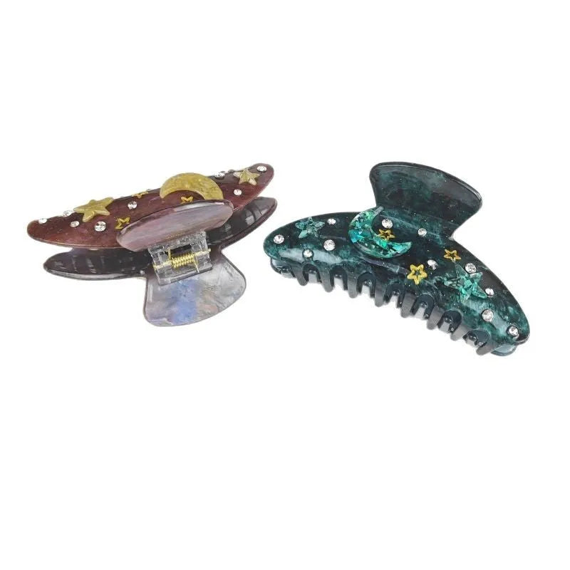 Oversized star barrettes in starry sky colours showing minimalist design and irregular elements