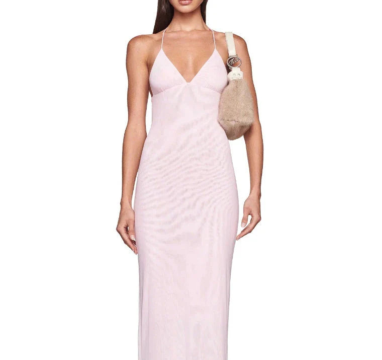 A stylish halter dress with a floral print and butterfly-inspired back, perfect for summer events and parties.