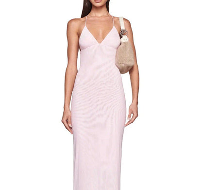 A stylish halter dress with a floral print and butterfly-inspired back, perfect for summer events and parties.