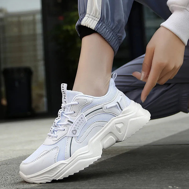 White women's thick-soled casual sports shoes with mesh upper, round toe, and buckle detail.