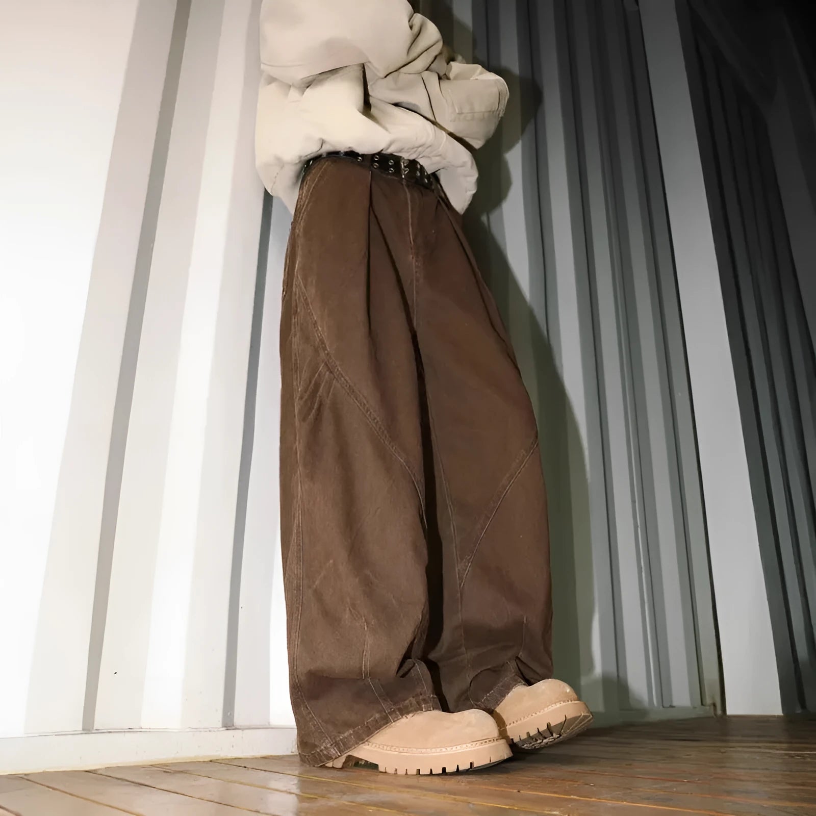 Man wearing pleated straight-leg trousers in a striped pattern with a micro elastic mid waist.