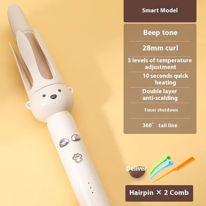 Beige automatic hair curler machine with negative ion technology and included styling stick on a table.