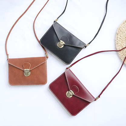 Retro shoulder messenger bag in cross square shape with flap and lock closure, showing internal mobile phone compartment