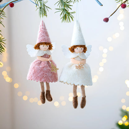 White and pink cloth felt Christmas angel skirt pendant ornament on a tree branch.