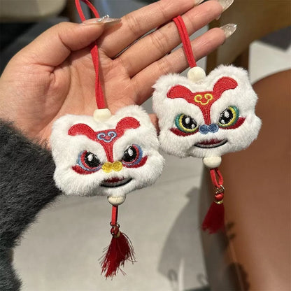 Handmade blue plush lion keychain with tassels and star stone decoration.