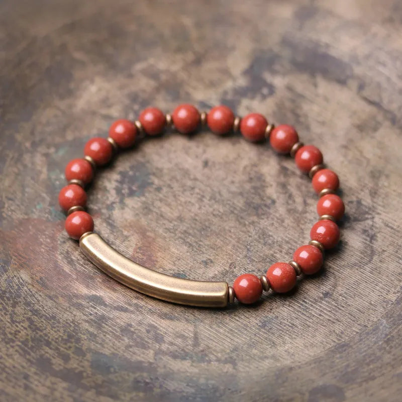 Layered stone and brass ethnic bracelet for men and women on a wrist.