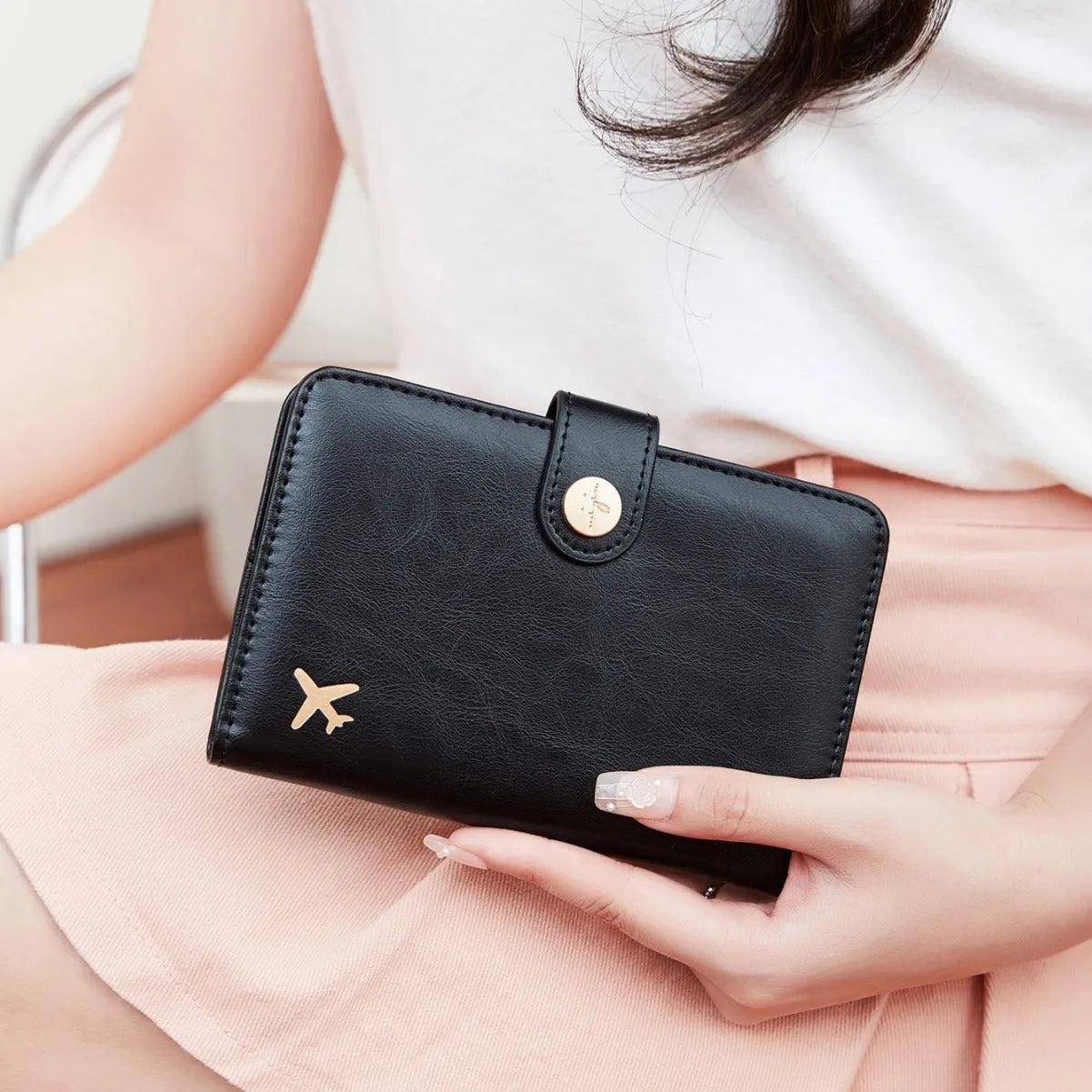 PU passport wallet with sewing line detail, shown in multiple colours including black, pink, and blue, featuring anti-theft swiping protection.