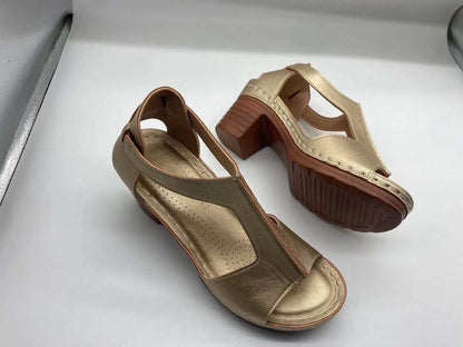 Women's beige peep toe wedge sandals with a buckle strap and low heel on a white background.