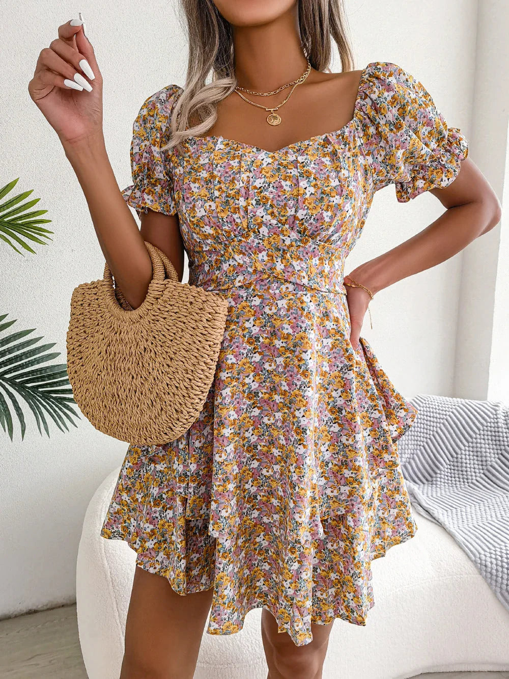 Stylish floral mini dress with ruffled skirt, high-waist design, and short sleeves for a flattering and comfortable summer look