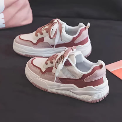 Pink and milky white low-top height-increasing sneakers with a rubber sole.