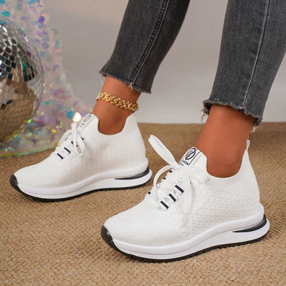 Women's flat lace-up mesh sneakers in black and white colours with round toe