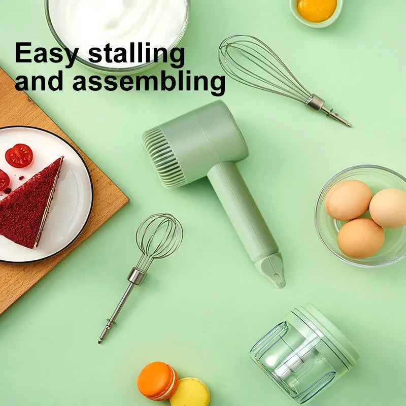 Green rechargeable electric hand mixer with whisk and beater attachments on a kitchen counter