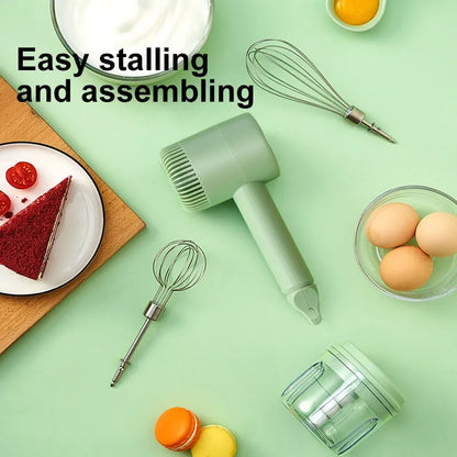 Green rechargeable electric hand mixer with whisk and beater attachments on a kitchen counter