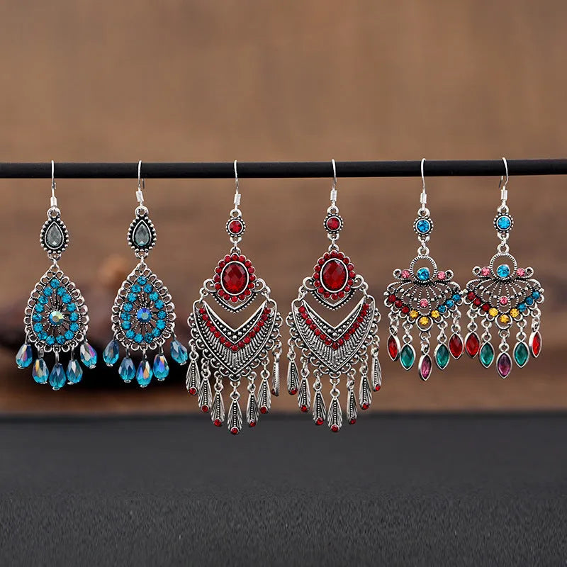 Purple drop-shaped alloy earrings with long fringe and crystal details on a retro style.