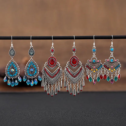 Purple drop-shaped alloy earrings with long fringe and crystal details on a retro style.