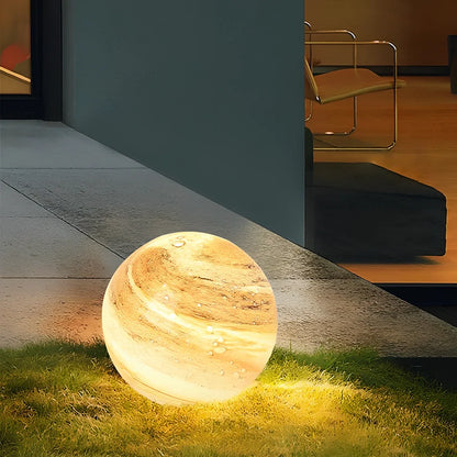 Solar lawn lamp in garden setting showing waterproof construction and LED illumination
