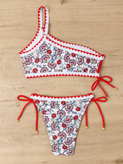Blue one-shoulder bikini set with floral pattern on mannequin