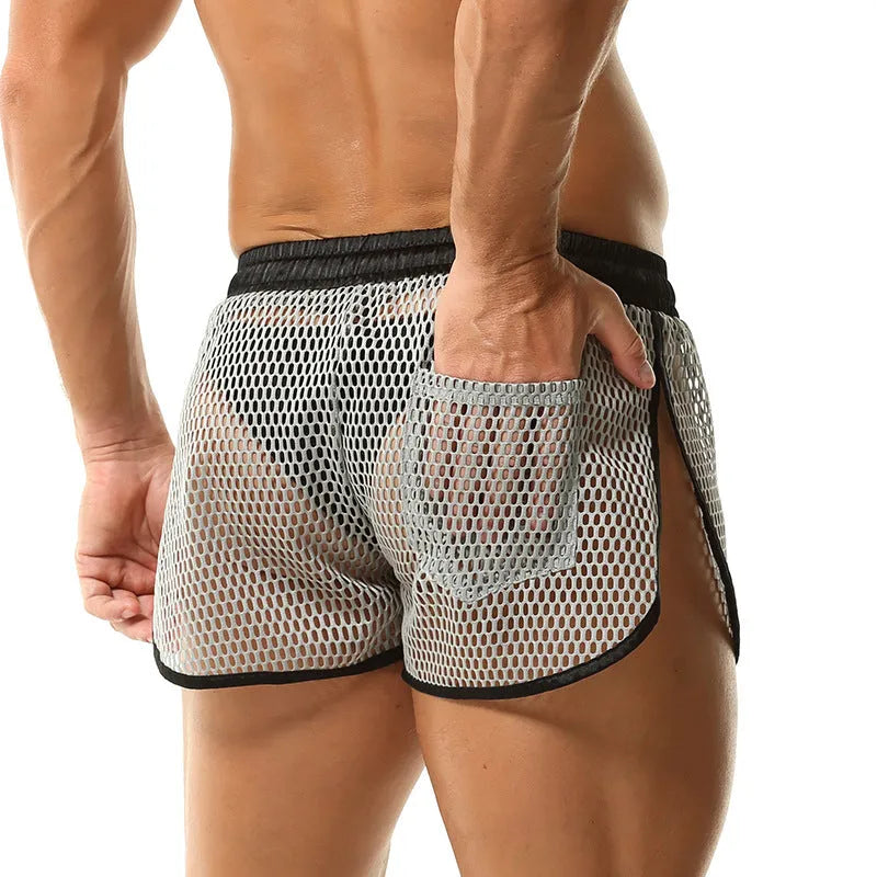 Men's solid colour loose fit polyester boxer shorts shown in black, white, grey, and red.