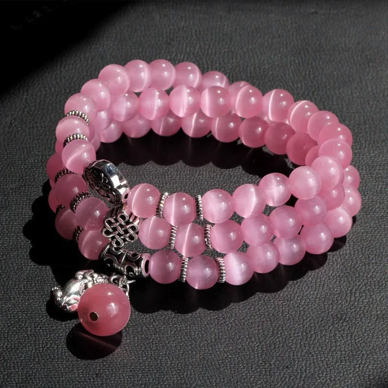 Crystal Opal Cat Eye Bracelet featuring three linked rings with geometric shapes, a lucky cat charm, and a versatile 52cm adjustable cord length suitable for women's casual and festival wear in Blue, Green, Lake Blue, Pink, White or Yellow.