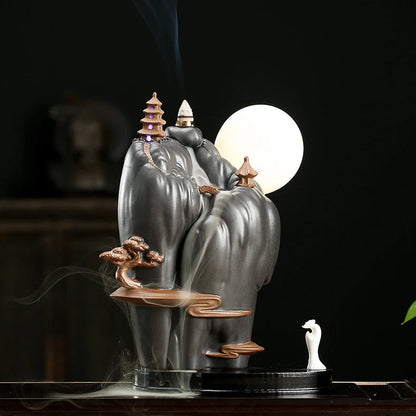Purple clay tea pet ornament with downward flowing incense smoke and warm LED illumination