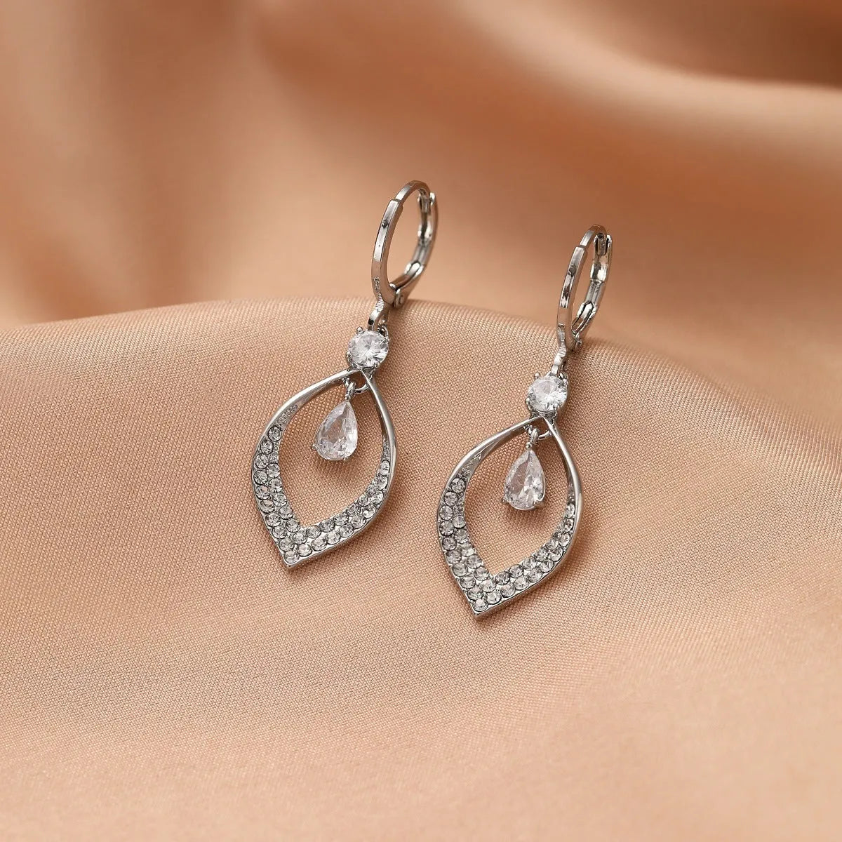 Women's copper teardrop tassel earrings with zircon detail and choice of gold or silver buckle.