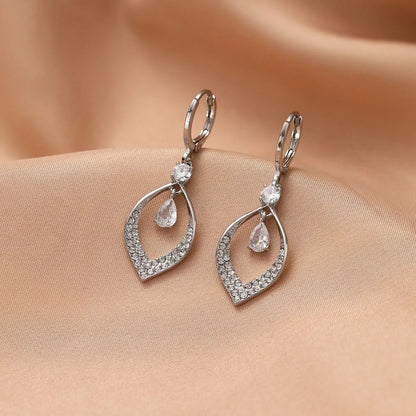 Women's copper teardrop tassel earrings with zircon detail and choice of gold or silver buckle.