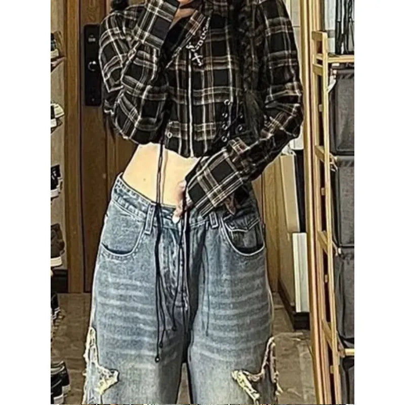 Blue high-waisted wide-leg denim trousers with a straight-leg cut on a model.