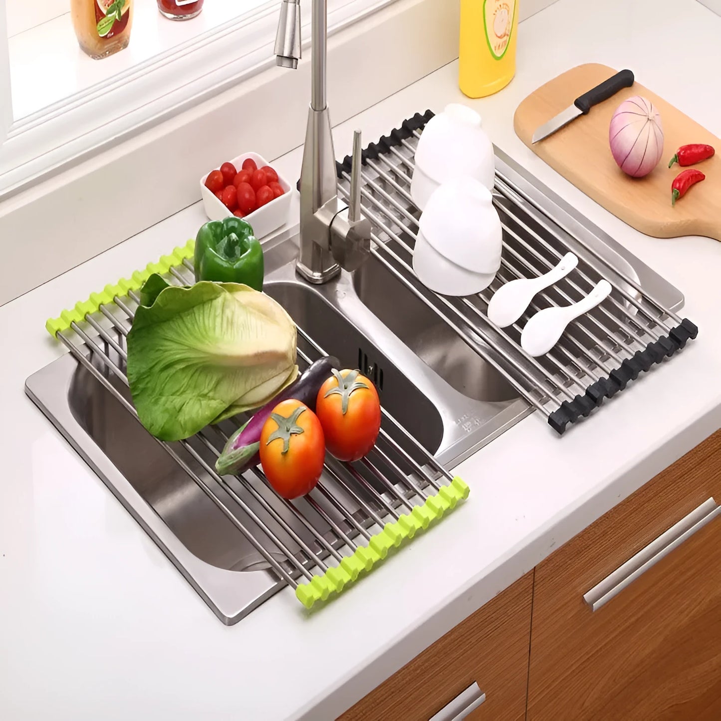 Folding stainless steel kitchen drain rack with coloured plastic tubes, shown open for use.