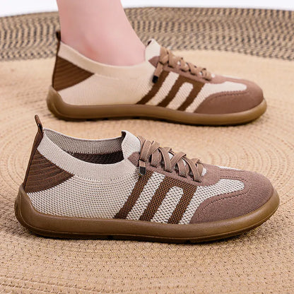 Retro style casual training shoes in flyknit mesh with a soft PU sole and flat heel.