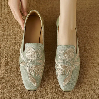 Women's embroidered low-cut flat pumps in beige with a round toe and soft sole.