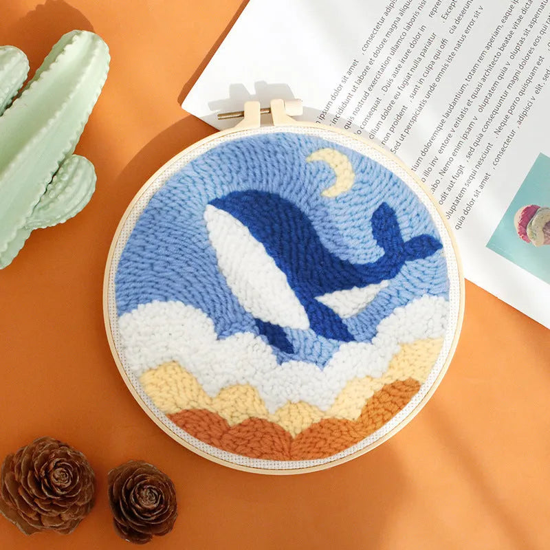 Handmade embroidery kit with cartoon animal designs on linen fabric including flamingo, whale and deer patterns