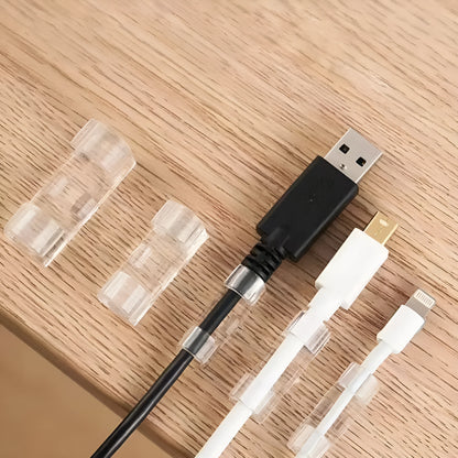 Transparent self-adhesive plastic cable clips for wire management, shown in a pack.