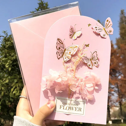 Handmade 3D butterfly greeting card with stand-up artificial flowers on coated paper, 16x10.5cm