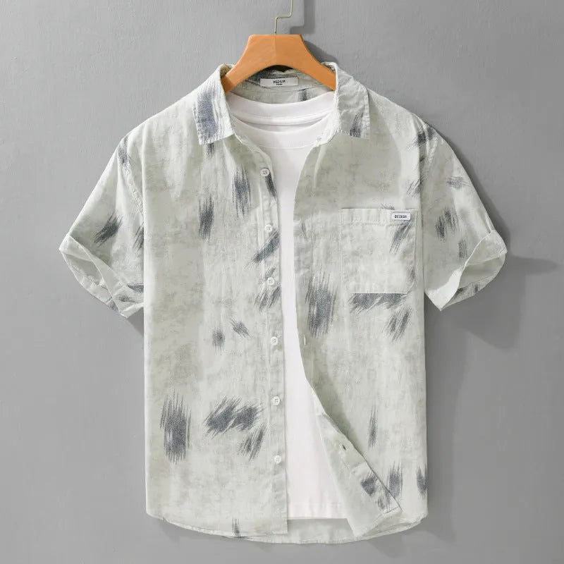 Light green men's loose-fit floral print short-sleeve cotton cardigan laid flat.