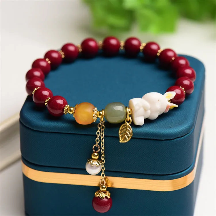 Traditional Chinese cinnabar bracelet with bunny design in purple-gold sand colour