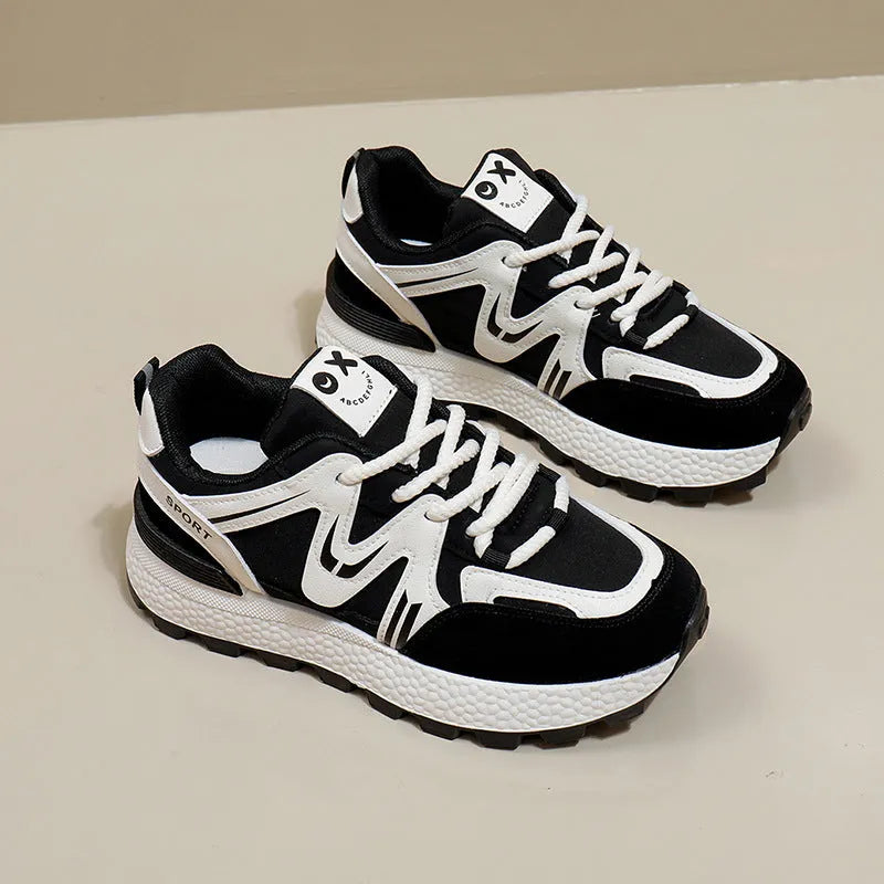 Women's black sports casual shoes with round toe and front lace-up design on a flat heel.