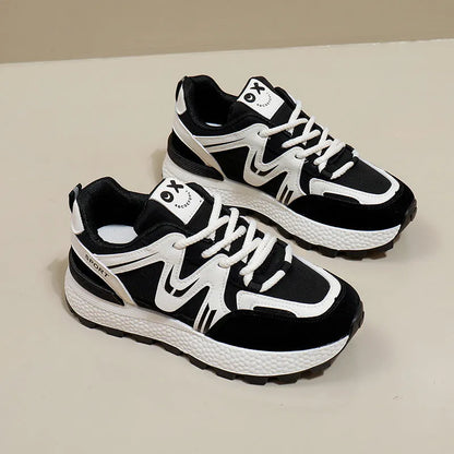 Women's black sports casual shoes with round toe and front lace-up design on a flat heel.
