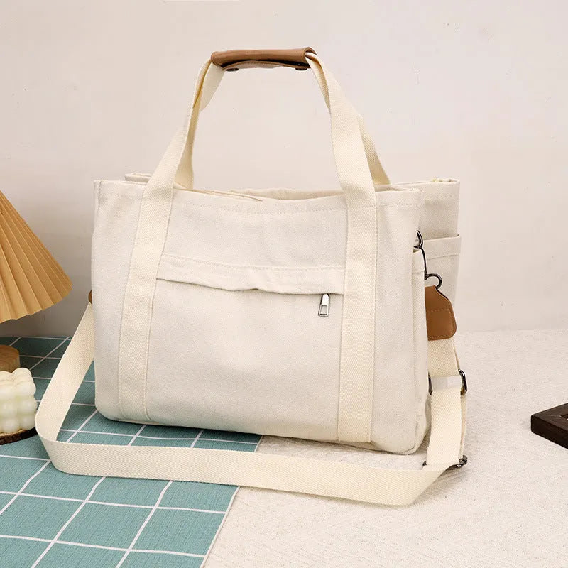 Large canvas tote bag in horizontal square shape with open-zip sides and internal organisers