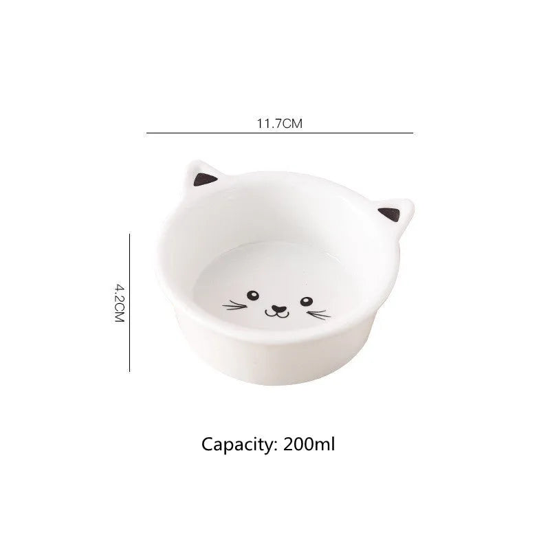 White ceramic pet food bowl with raised cat face design for cats and small dogs