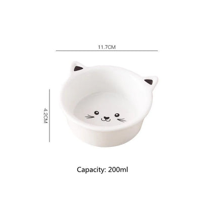 White ceramic pet food bowl with raised cat face design for cats and small dogs